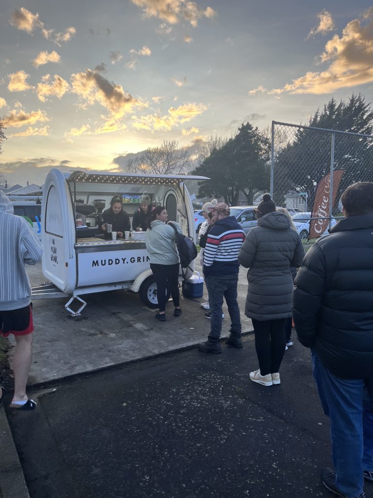 a photo of a coffee cart with a line of people in front of it